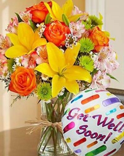 Just what the doctor ordered! Inspired by the spectrum of color found in the rolling fields of Europe, our florists designed this gathering of fresh roses, lilies, alstroemeria, poms and more inside a stylish clear glass vase tied with raffia as a nod to rustic European style. Includes a "Get Well" 18" Mylar balloon.
