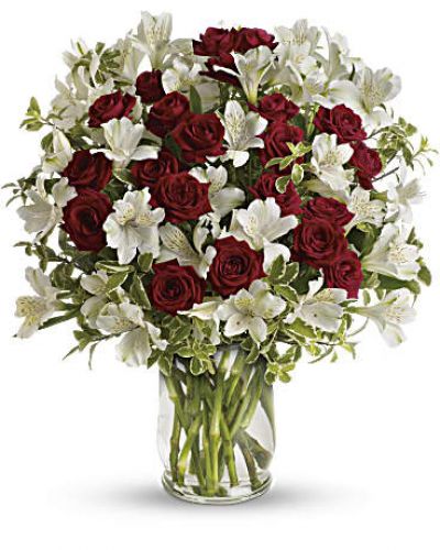 <p>Roses and romance - a match made in heaven. Our endlessly elegant bouquet combines passionate red roses with heavenly white blossoms in a stylish glass hurricane vase. What a classic way to say you care!<br />
Includes red spray roses, white alstroemeria and pretty pitta negra.</p>