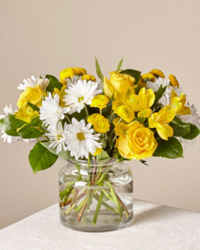This sun-kissed assortment of white and yellow blooms brightens the room with radiance. Whether you want to boost someone’s mood or send happiness, this bouquet is just the right pick.