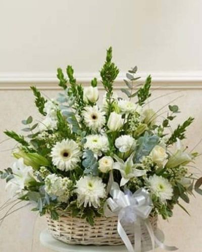 <p>Send an expression of your sympathy and compassion with this sophisticated and elegant arrangement of white roses, hybrid lilies, Gerbera daisies and more. Appropriate for friends, family and business associates to send directly to the funeral home or to the family's home.</p>