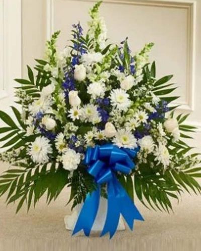<p>Our elegant floor basket arrangement is a heartfelt way to express your deepest sympathies. With blue flowers to symbolize tranquility and white flowers to symbolize peace, this beautiful gathering of fresh roses, snapdragons carnations, blue delphinium and more conveys care and concern during this difficult time. Appropriate for family, friends or business associates to send directly to the funeral home.</p>