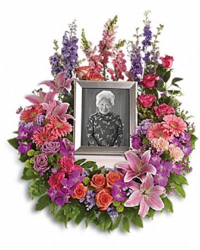 <div class="m-pdp-tabs-description">
<div id="mark-1" class="m-pdp-tabs-marketing-description">Devotion is expressed and beautiful memories cherished with this deep-hued and softly elegant wreath. A lovely reminder of your affection and respect.</div>
</div>
<p id="arrngDescp">A mix of dramatic flowers such as purple orchids and asters, orange, dark pink and lavender roses, pink and peach carnations, lavender larkspur, green chrysanthemums, and a range of pink blooms including oriental lilies, gerbers, snapdragons and more. Please note: Arrangement does not include picture frame.</p>