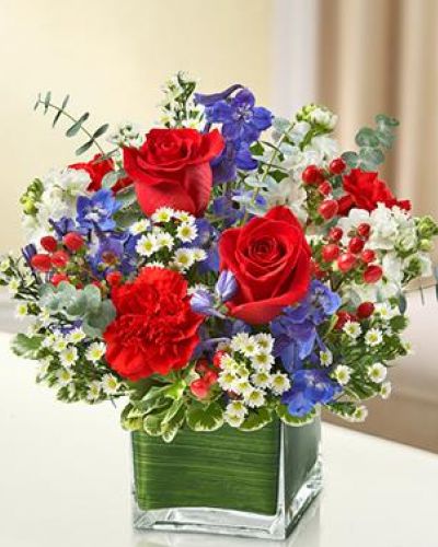<p>This lovely red, white and blue arrangement offers a beautiful reflection of your patriotism.</p>
<p>Fresh red roses, delphinium, stock, carnations and hypericum, designed in a cube vase make any occasion special.</p>