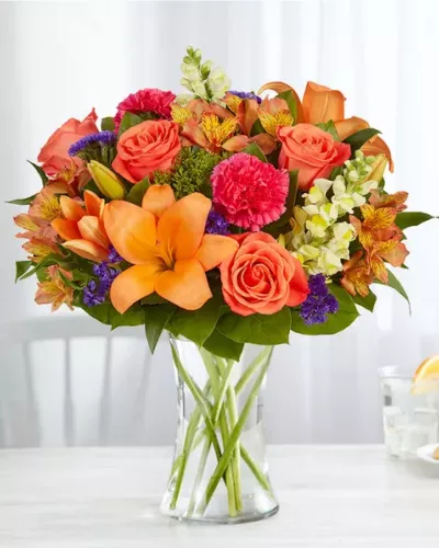 Putting a bright start in somebody’s day starts with a beautiful gift. Our delightfully vibrant bouquet is filled with a medley of blooms in cheerful pops of orange, pink and yellow, with plenty of lush greenery mixed in. Designed by the talented Breanna Cartwright from Fresh Ideas Flowers Company in Modesto, California, it’s the perfect pick-me-up surprise, whatever the sentiment.