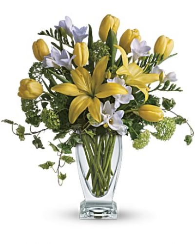 <div id="mark-2" class="m-pdp-tabs-marketing-description">A rhapsody in yellow. Say "get well soon" or "have a happy day" with this sunny assorted bouquet. Everyone's favorite spring flowers are here - yellow lilies, yellow tulips, with accents of deliciously fragrant freesia flowers.</div>
&nbsp;
<div id="desc-2">
<ul>
 	<li>Fragrant white freesia, fresh yellow tulips and asiatic lilies are mixed with beautiful green viburnum and graceful tendrils of ivy in a stylish, clear glass vase,</li>
</ul>
</div>