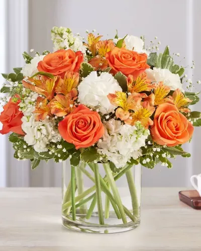 <p>The sweet citrus shades in our charming bouquet bring your sentiments to life. Loosely gathered inside a clear cylinder vase, the mix of vibrant orange and creamy white blooms makes special milestones and everyday moments even more memorable.</p>